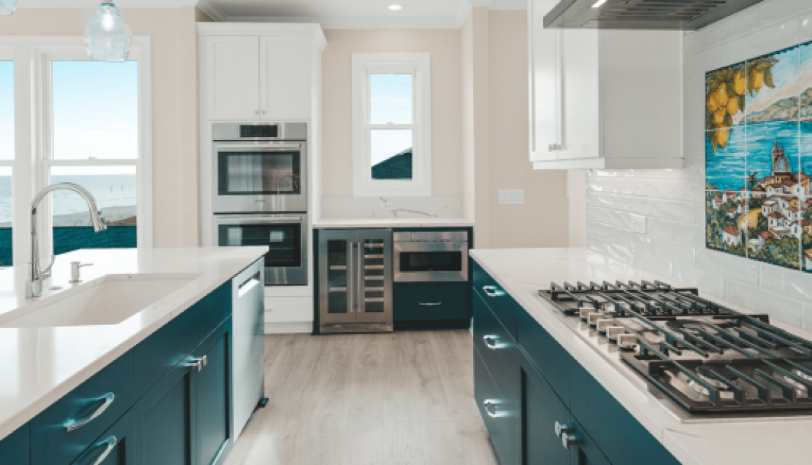 luxury coastal kitchen with blue cabinetry and white countertops