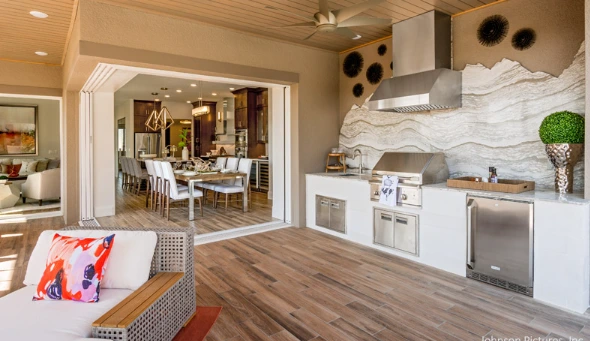 : Outdoor living space with a grill, dining area, and cozy seating, perfect for retirees enjoying al fresco time.